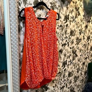 Sleeveless top, relaxed fit with bow detail at back neck.